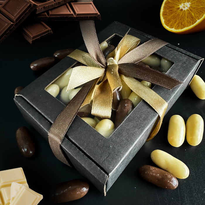 Šokolādes dražejas ar apelsīnu cukātiem kastītē